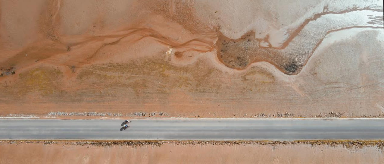 A lone rider on the causeway, with tidal sands stretching away on either side
